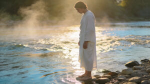 Person standing beside flowing water symbolizing repentance, mercy, spiritual cleansing, and returning to grace through Psalm prayer work